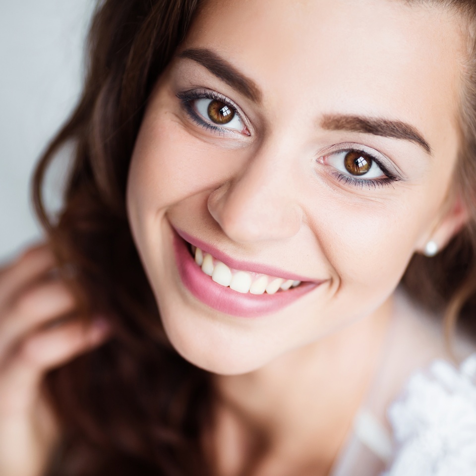 Smiling woman with bright, white teeth looking at the camera