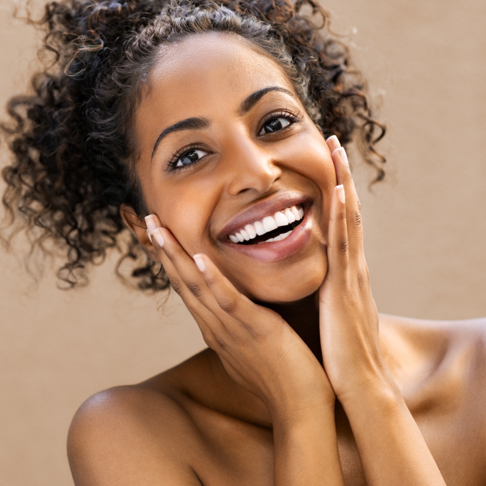Young woman smiling with a bright, white smile after teeth whitening