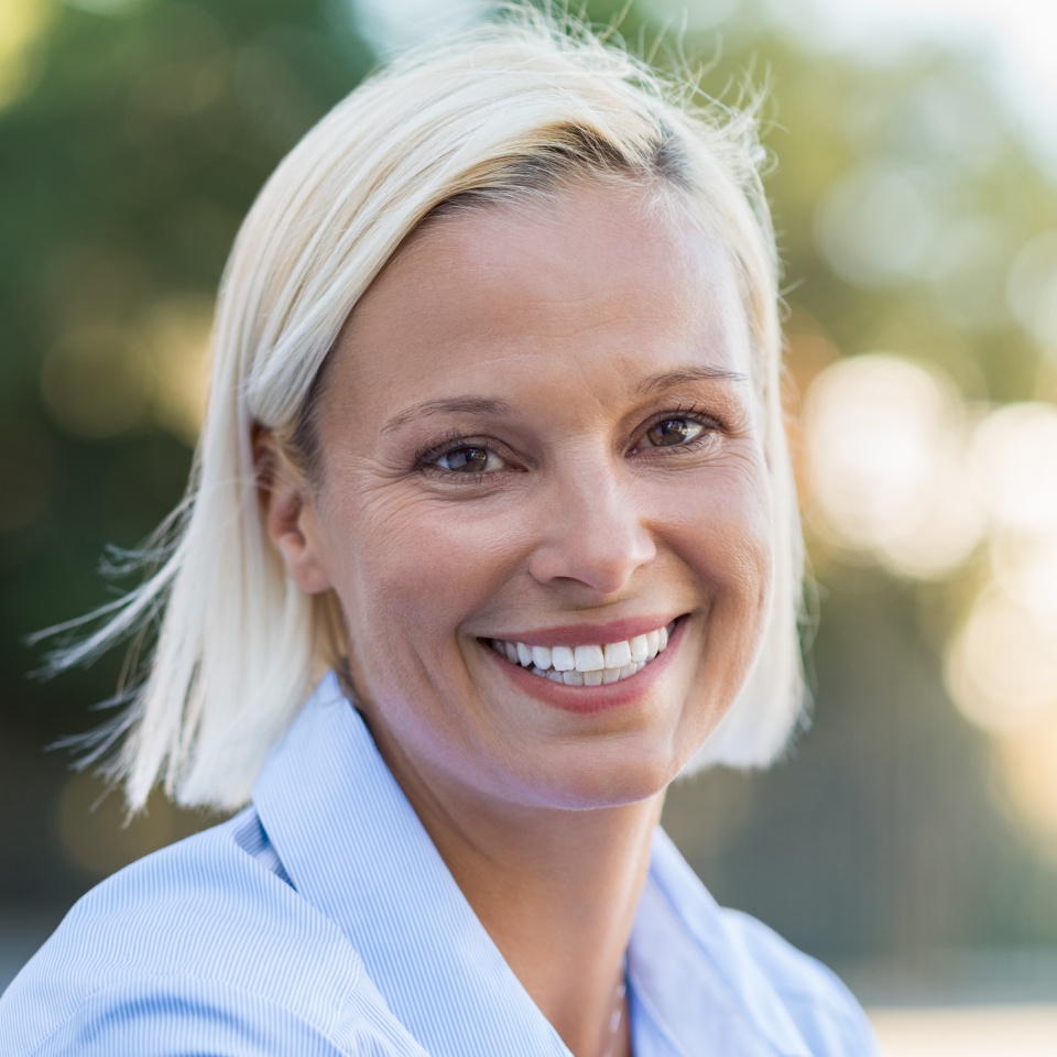 Smiling mature woman relaxing outdoors in a park