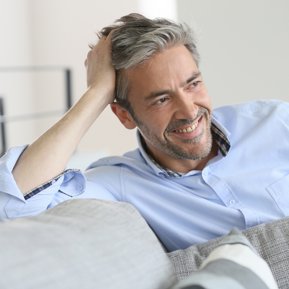 Smiling handsome 45-year-old man relaxing at home