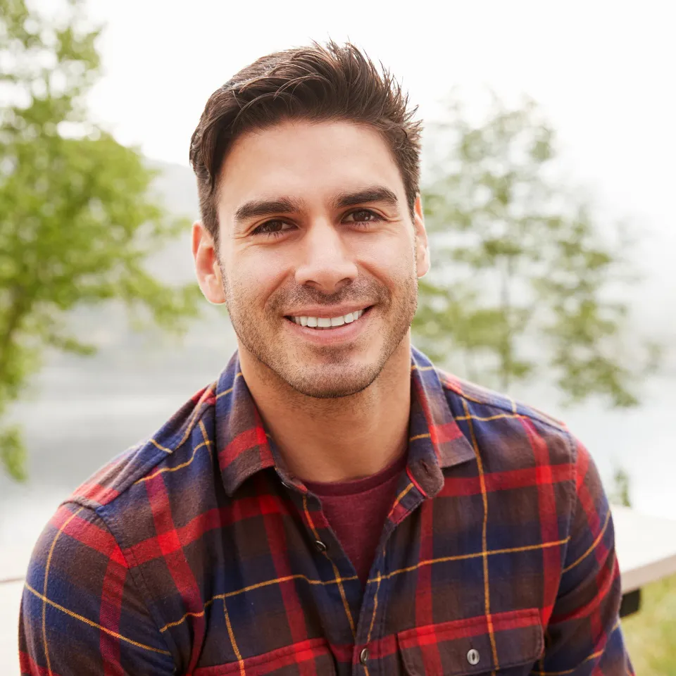 Young man smiling in a park