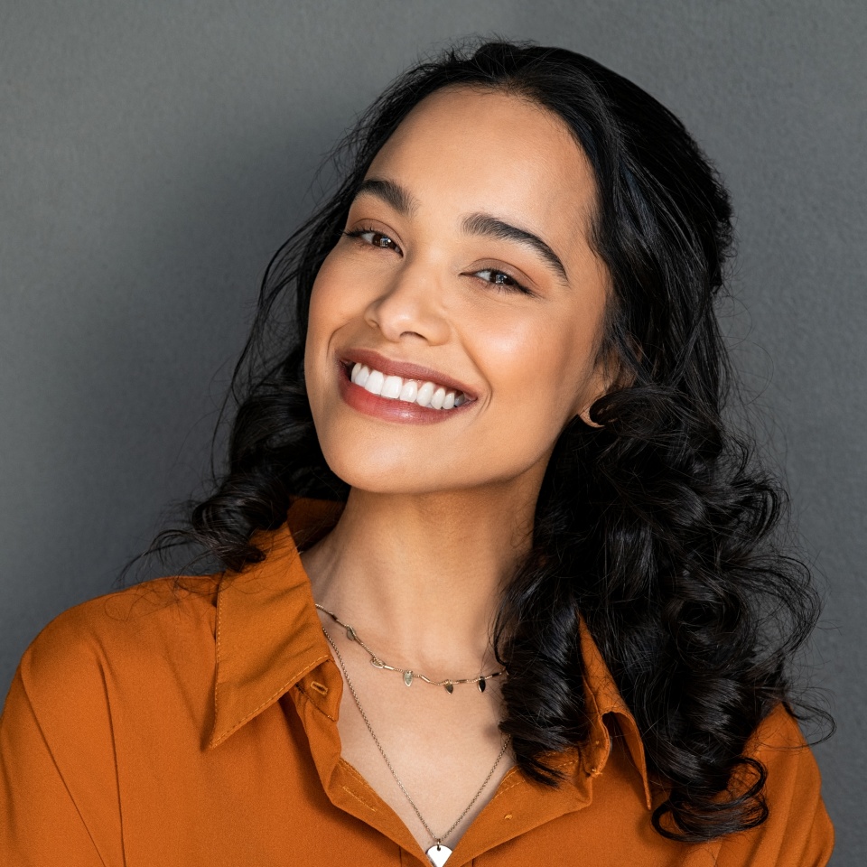 Close-up of a woman's face with a bright, white smile