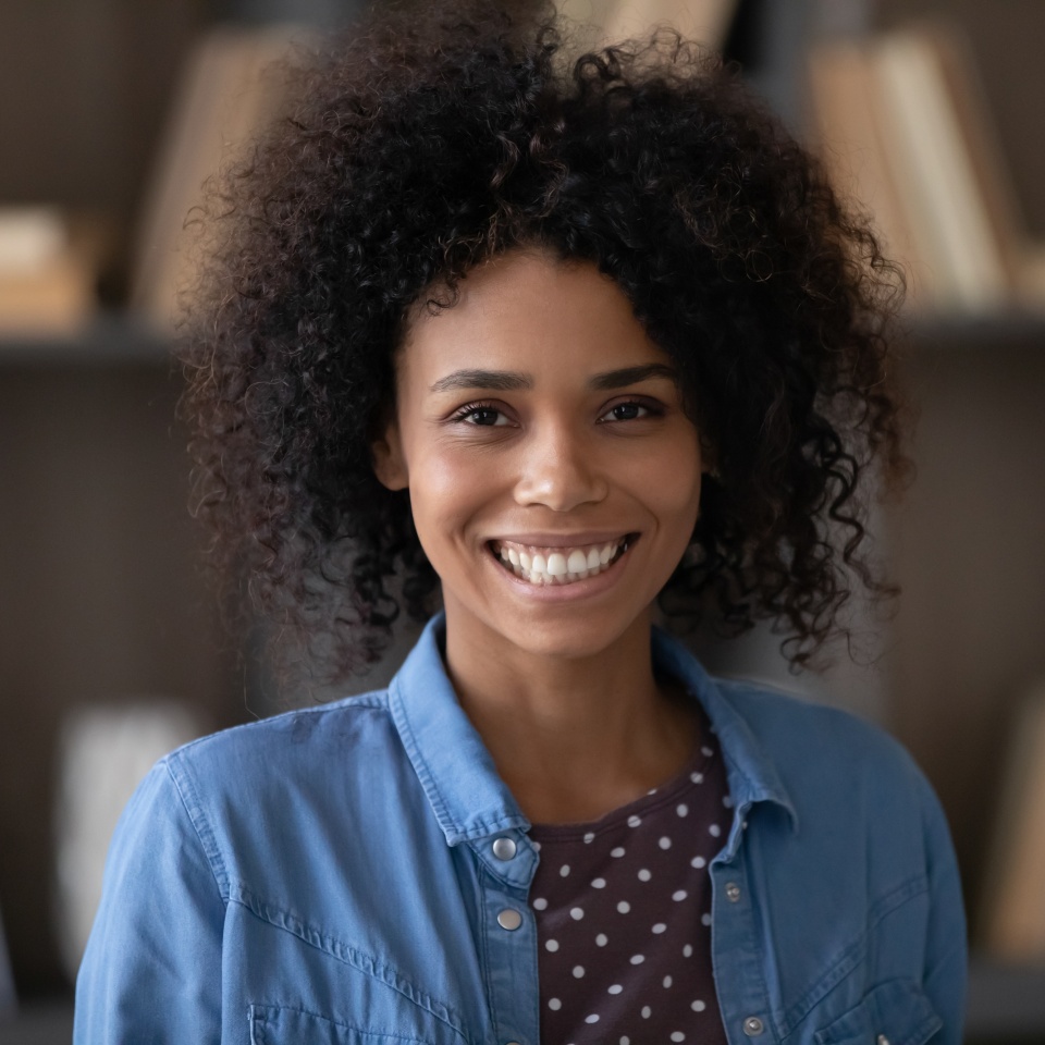 Head shot portrait of a smiling businesswoman looking at the camera