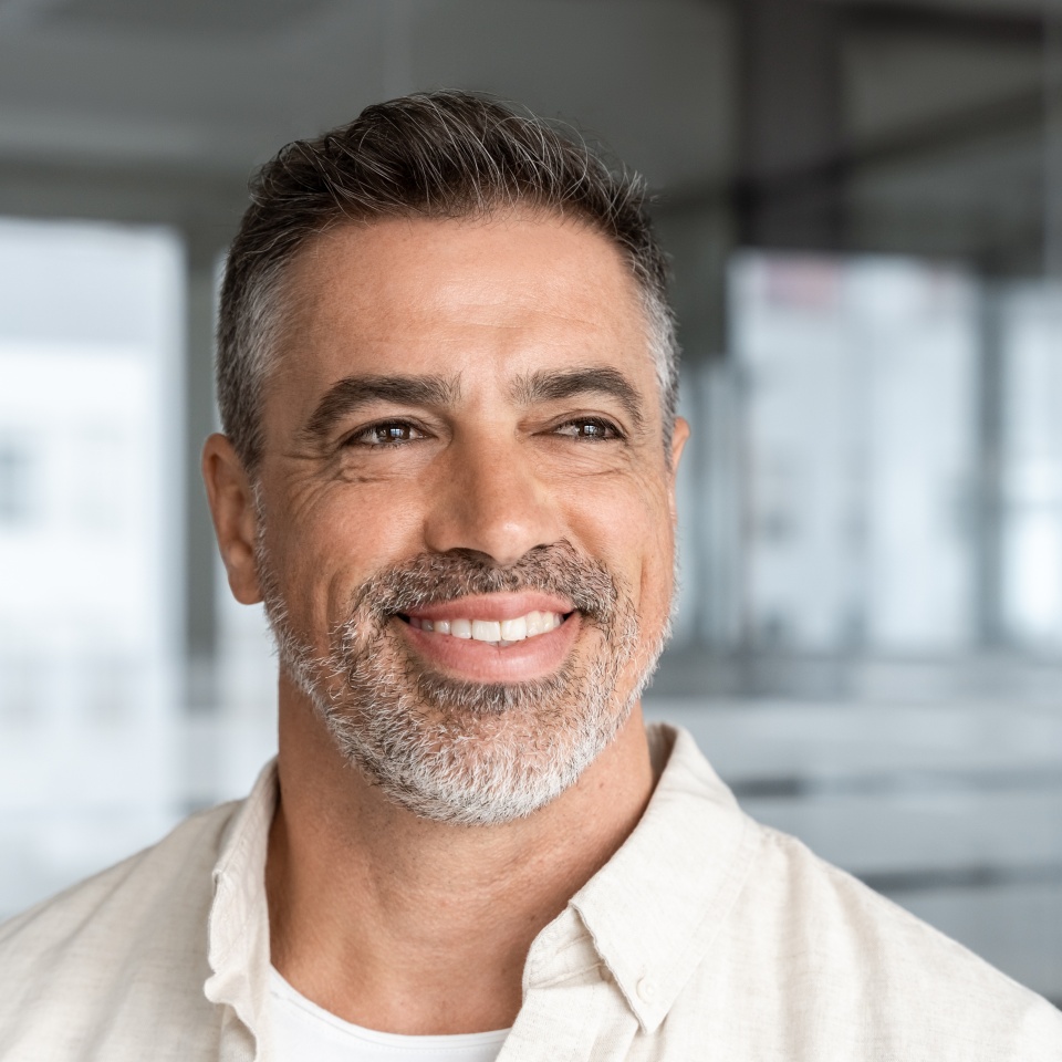 Confident mature businessman smiling in an office setting