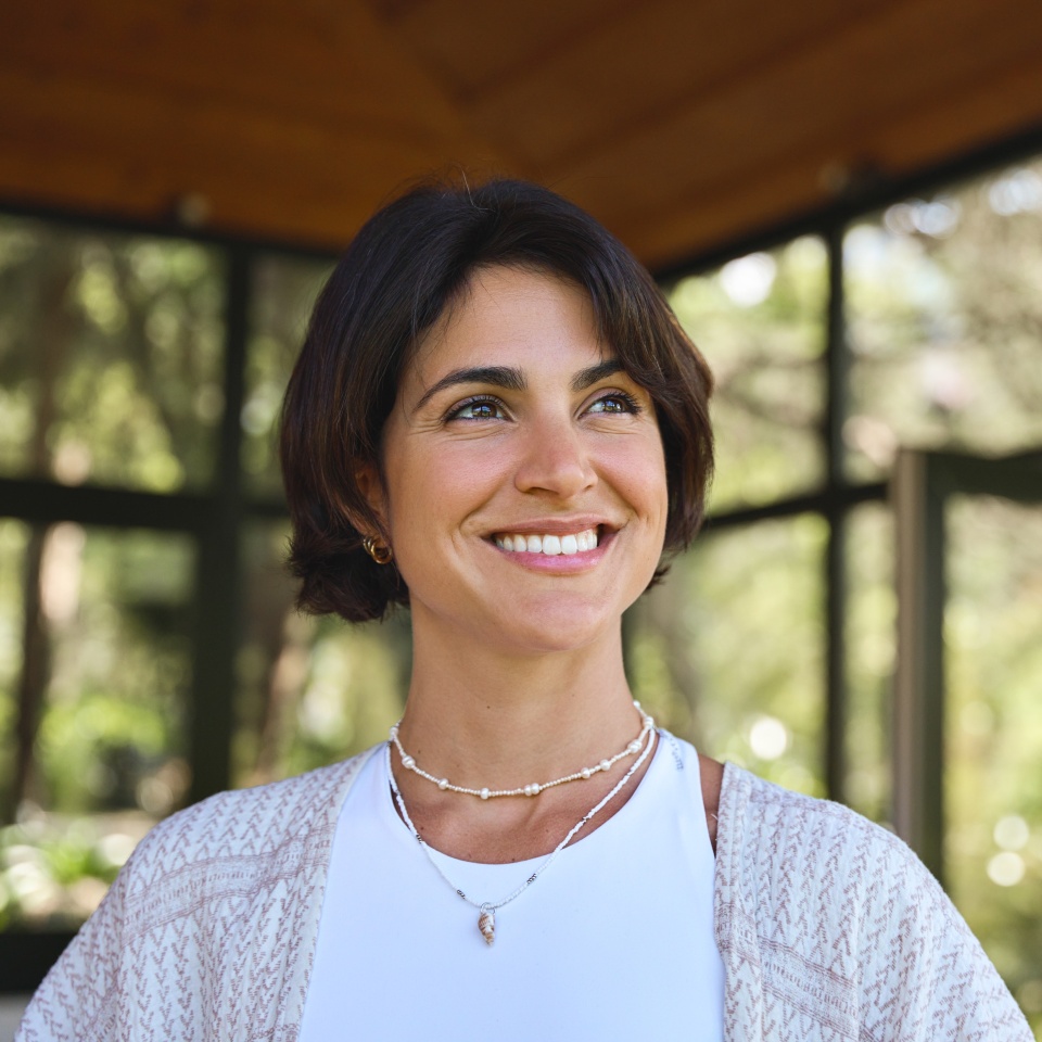 Smiling woman standing in a bright studio setting