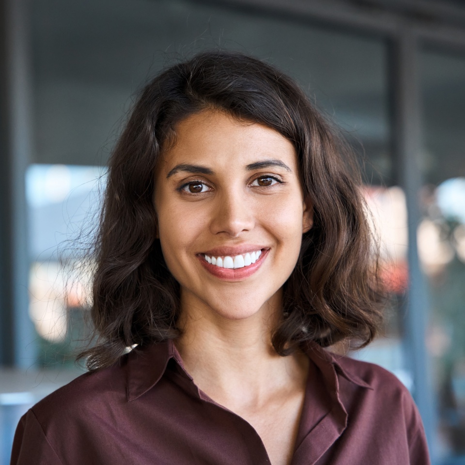 Close-up headshot of a smiling businesswoman looking at the camera