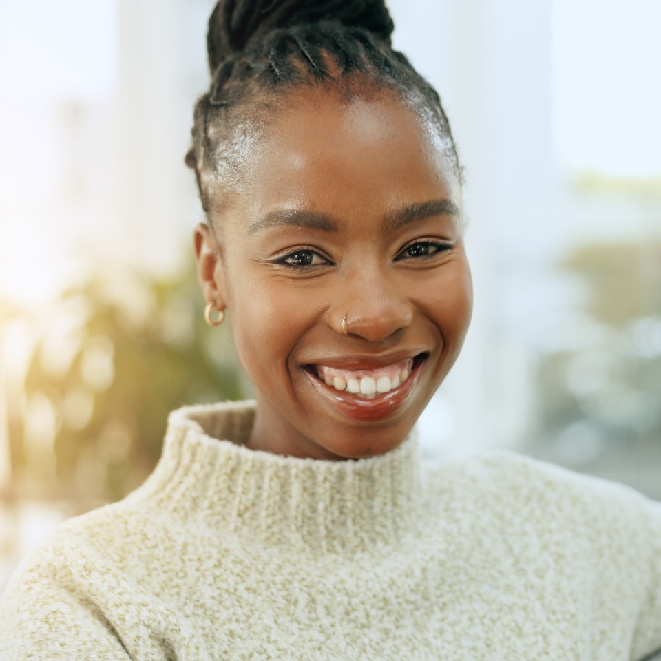 Smiling woman relaxing on a sofa at home