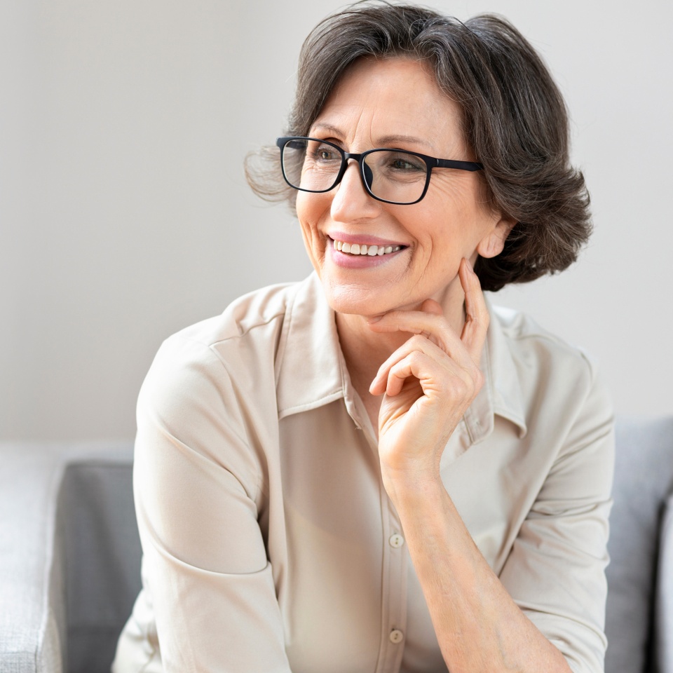 Portrait of smiling middle aged woman in glasses, copy space