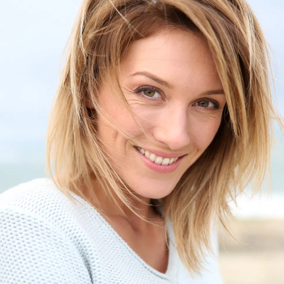 Portrait of a smiling blonde woman in her forties